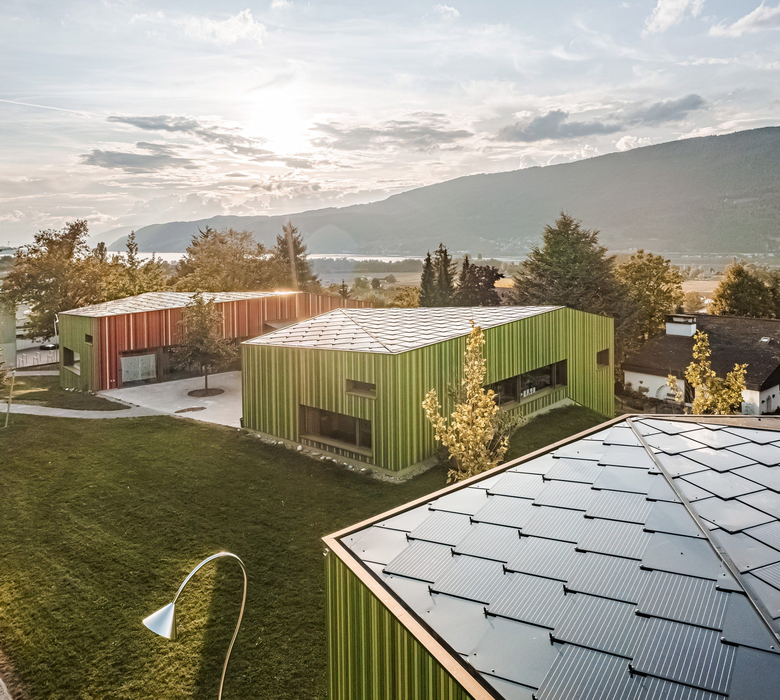 Die Abbildung zeigt Photovoltaikmodule auf den Dächern eines Kindergartens in Ipsach in der Schweiz.